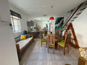 a living room with a couch and a table at PRIBO's in Flic-en-Flac