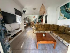 a living room with a couch and a coffee table at PRIBO's in Flic-en-Flac