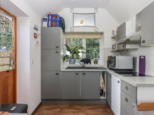 a kitchen with a sink and a refrigerator at The Old Telephone Exchange in Exeter