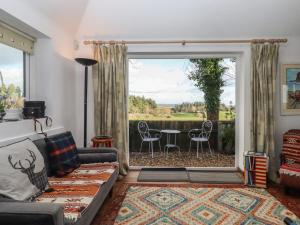 a living room with a couch and a large window at The Old Telephone Exchange in Exeter
