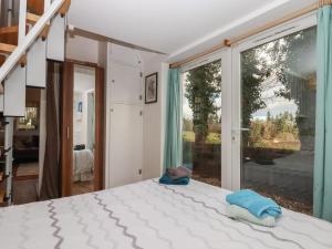 a bedroom with a bed and a large window at The Old Telephone Exchange in Exeter