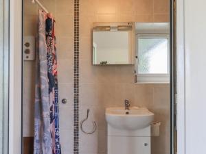 a bathroom with a sink and a toilet and a mirror at The Old Telephone Exchange in Exeter