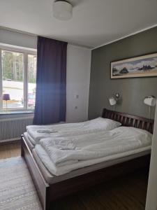 a large bed in a room with a window at Dorotea Logi B&B in Dorotea