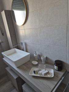 a bathroom with a sink and a mirror at Ca d'la Mondina Apartment in Vercelli +11 photos