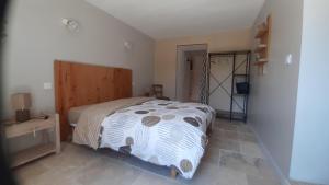 a bedroom with a bed and a tv in a room at Maison de campagne in La Fouillade