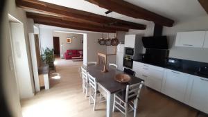 a kitchen and dining room with a table and chairs at Maison de campagne in La Fouillade
