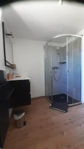 a bathroom with a glass shower in a room at Maison de campagne in La Fouillade +6 photos