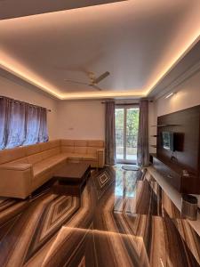 a living room with a couch and a television at Marshmallow - by MA Homes in Morjim