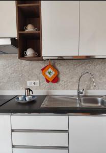 a kitchen with white cabinets and a sink and a counter at MR1 House Gallipoli in Gallipoli +39 photos