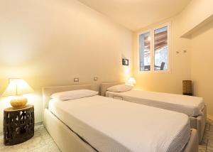 a bedroom with two beds and a lamp on a table at Villa Ritter Orizzonte in Cavoli