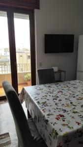 a dining room table with a flowered table cloth on it at MR1 House Gallipoli in Gallipoli