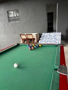 a pool table with balls on top of it at Casa em Jacumã in Conde