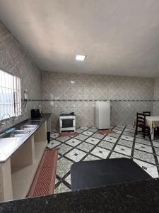 a kitchen with a stove and a refrigerator at Casa em Jacumã in Conde