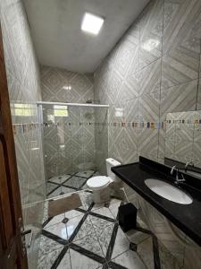 a bathroom with a sink and a toilet at Casa em Jacumã in Conde +5 photos