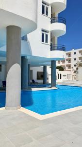 a building with a swimming pool in front of a building at The Navigator - Ocean Heights & Residences in Olhos de Água