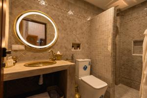 a bathroom with a toilet and a sink and a mirror at Riad Golden in Rabat +84 photos