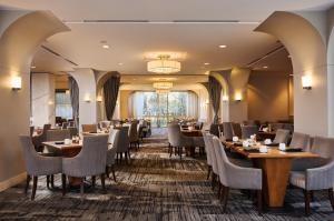 a restaurant with tables and chairs and a large window at Renaissance Chicago O'Hare Suites Hotel in Rosemont