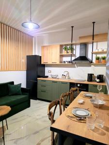 a kitchen and living room with a table and a couch at Anthouli Homes 1, steps from beach and centre in Kardamaina