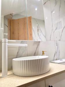 a bathroom with a white sink and a mirror at Anthouli Homes 1, steps from beach and centre in Kardamaina +22 photos