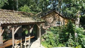 a stone house with a table and chairs in a garden at The Hyacint House in Den Andel +12 photos