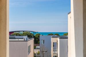 a view of the ocean from an apartment building at Talea Elegant Escape by PikHost in Lezhë