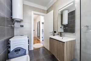 a bathroom with a toilet and a sink at Talea Elegant Escape by PikHost in Lezhë +20 photos