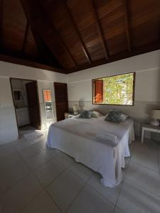 a bedroom with a large bed and a window at Casa bela in Cartagena de Indias