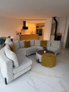 a living room with two couches and a table at Maison moderne in Saint-Julien-de-Concelles