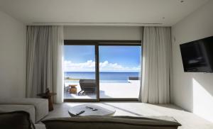 a living room with a view of the ocean at Fenia's Paradise Villa in Houlakia