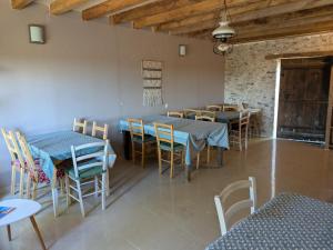 a dining room with blue tables and chairs at Bus magique avec tente glamping in Saint-Palais
