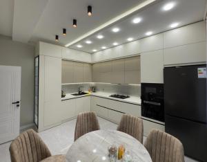a kitchen with a table and chairs in a room at Modern Villa in Quba City Center in Quba