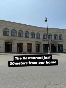 a building with a sign that reads the restaurant just sellers from our home at Modern Villa in Quba City Center in Quba