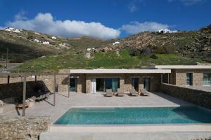 a villa with a swimming pool and a house at Fenia's Paradise Villa in Houlakia