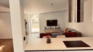 a living room with a couch and a table at Solar dos Arcos • Luxury Rural Retreat & Heated Po in Macieira da Lixa