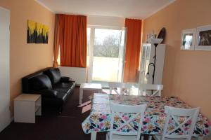 a living room with a table and chairs and a couch at Ferienwohnung an der Ostsee E311 in Brasilien