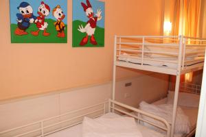 a bedroom with a bunk bed and two posters on the wall at Ferienwohnung an der Ostsee E311 in Brasilien