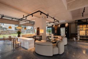 a large living room with a couch and a table at Meadowscape Resort at Yulong River - Karst Views & Infinity Pool & Tickets Reservation Service & Free Laundry in Yangshuo