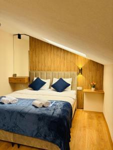 a bedroom with a large bed with towels on it at TASY Guest House - Luxury Rooms in the Heart od SHIROK SOKAK in Bitola