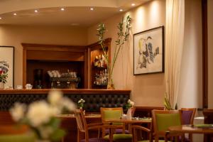 a restaurant with tables and chairs and a bar at Hotel Duomo - Etruria Collection in Orvieto