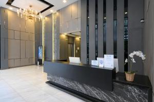 a lobby with a reception desk in a building at O2 Grand Suvarnabhumi Airport - Free Scheduled Shuttle from Hotel to Suvarnabhumi Airport in Bang Phli +43 photos