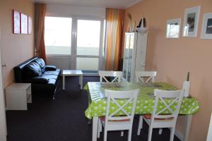 a living room with a table and chairs and a couch at Fereinwohnung an der Ostsee E312 in Schönberg