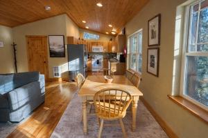 a kitchen and living room with a table and a couch at River Song Cabin home in Leavenworth +40 photos