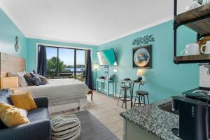 a bedroom with a bed and a living room at Pirates Bay B215 in Fort Walton Beach +13 photos