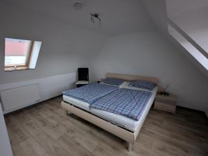 a bedroom with a bed in a white room at Ferienwohnung in Schkölen in Schkölen