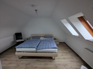 a bedroom with a bed in a white room at Ferienwohnung in Schkölen in Schkölen