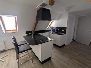 a kitchen with a counter and a chair in a room at Ferienwohnung in Schkölen in Schkölen