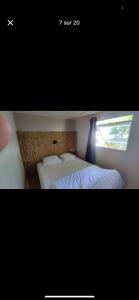 a bedroom with two beds and a window at Nature in Saint-Pierre-dʼOléron