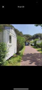 a picture of a white house and a dirt road at Nature in Saint-Pierre-dʼOléron