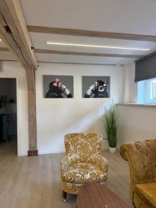 a living room with a chair and pictures on the wall at Alter Speicher in Schönberg