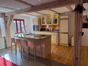 a kitchen with an island with bar stools at Alter Speicher in Schönberg